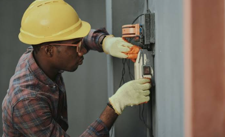 Professional Florida Electrician inspecting a circuit breaker panel